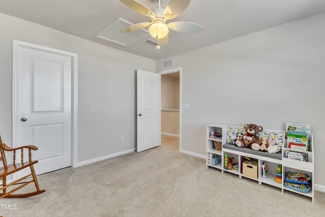 game room featuring light colored carpet and ceiling fan