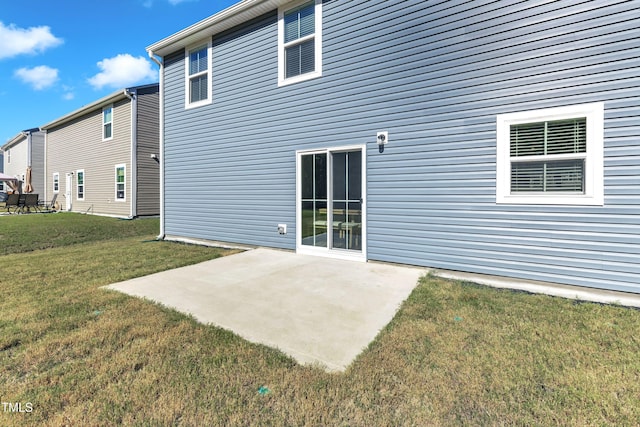 back of house featuring a yard and a patio