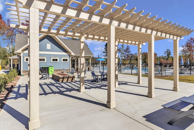 view of patio with a pergola and a fire pit