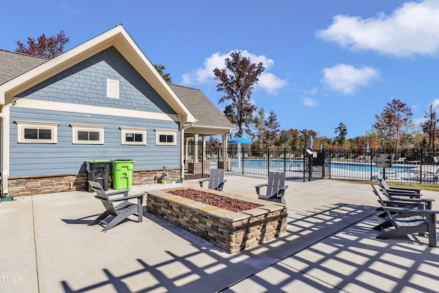 view of patio / terrace with a fenced in pool and an outdoor fire pit