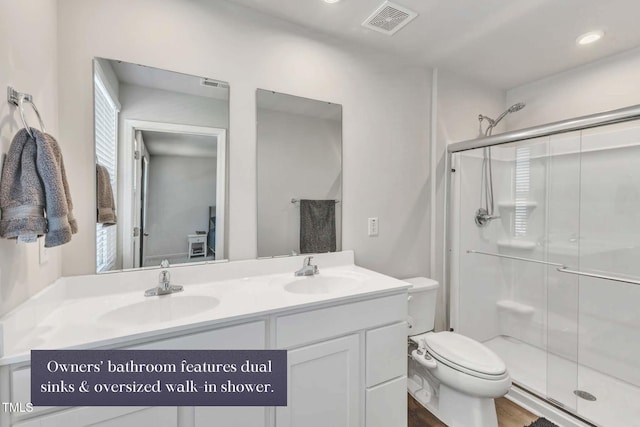 bathroom featuring hardwood / wood-style flooring, vanity, toilet, and walk in shower