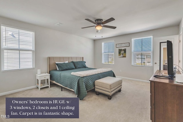 bedroom with multiple windows, light colored carpet, and ceiling fan