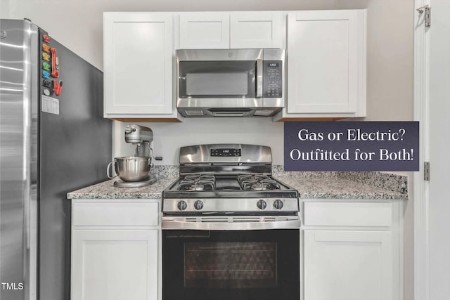 kitchen featuring white cabinets, light stone countertops, and appliances with stainless steel finishes