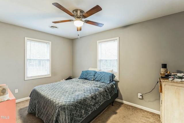 bedroom featuring carpet, ceiling fan, and multiple windows