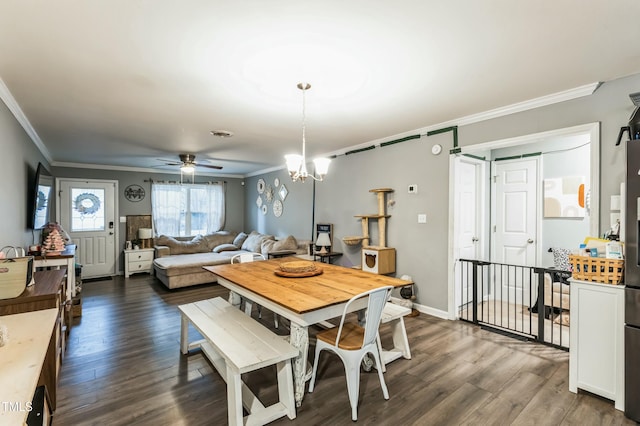 dining room featuring dark hardwood / wood-style flooring, ceiling fan with notable chandelier, and ornamental molding