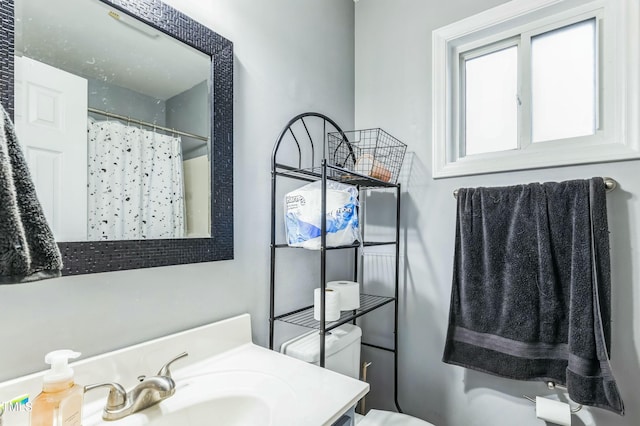 bathroom with a shower with curtain, toilet, and vanity