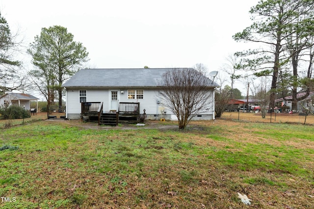 rear view of property featuring a deck and a lawn