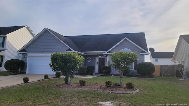 ranch-style home featuring a garage and a front lawn