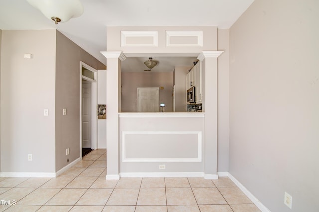 interior space featuring white cabinetry and light tile patterned floors