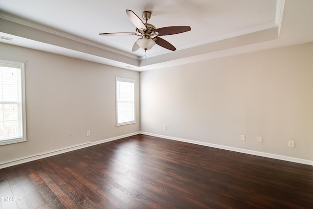 unfurnished room with dark hardwood / wood-style flooring, a tray ceiling, ornamental molding, and ceiling fan