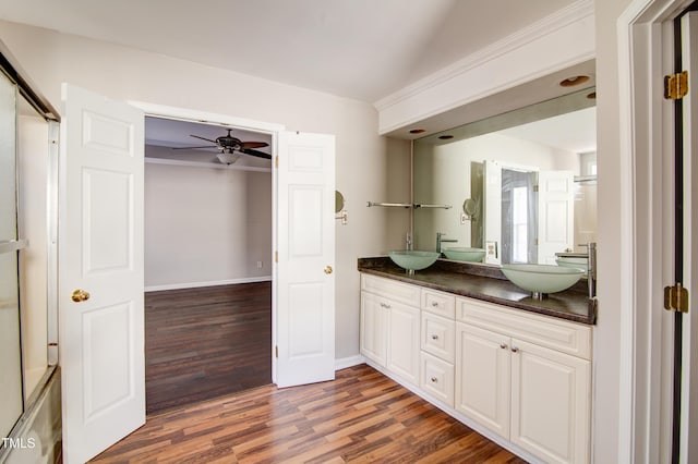 bathroom featuring vanity, hardwood / wood-style flooring, vaulted ceiling, and ceiling fan