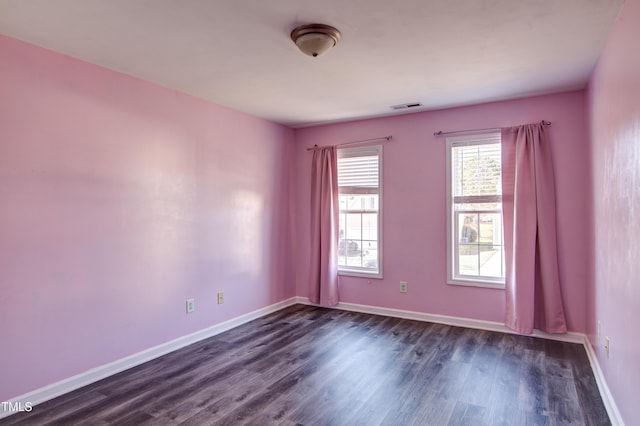 spare room with dark wood-type flooring