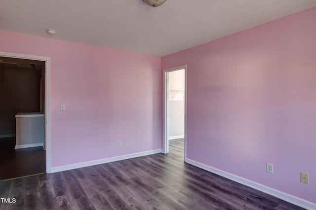 spare room featuring dark hardwood / wood-style flooring