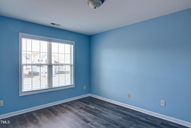 spare room featuring dark hardwood / wood-style floors