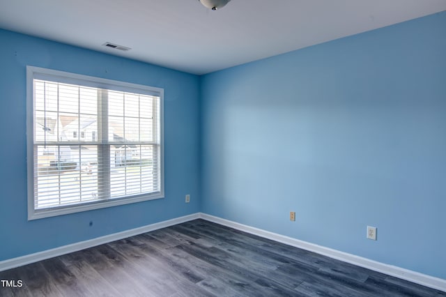 spare room featuring dark hardwood / wood-style flooring