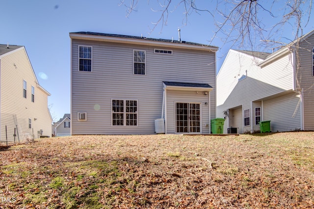 back of house with central AC unit