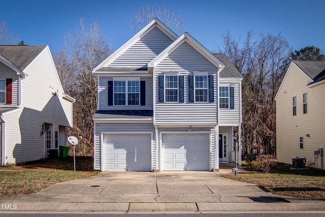 front facade featuring a garage and cooling unit