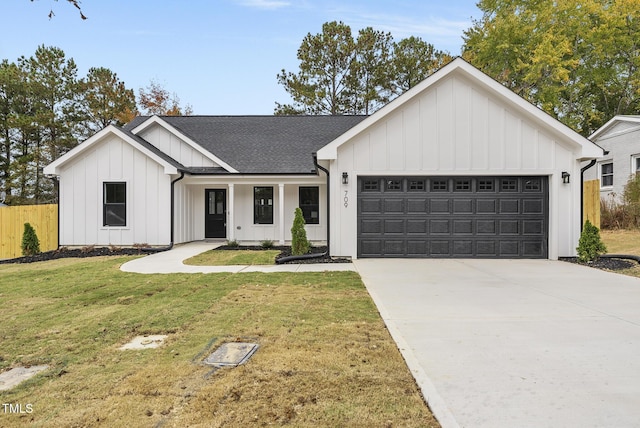 modern farmhouse featuring a garage and a front lawn