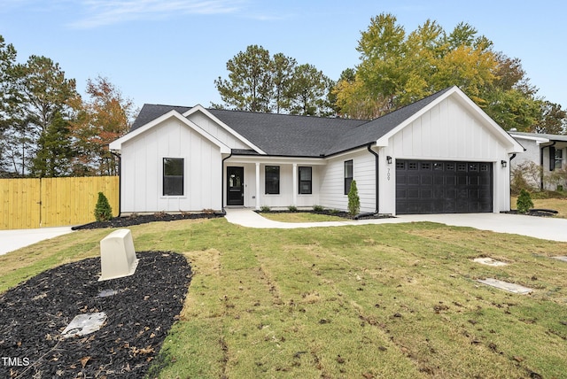 modern inspired farmhouse featuring a front lawn and a garage