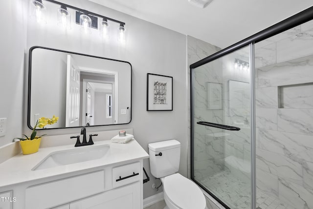 bathroom with vanity, an enclosed shower, and toilet