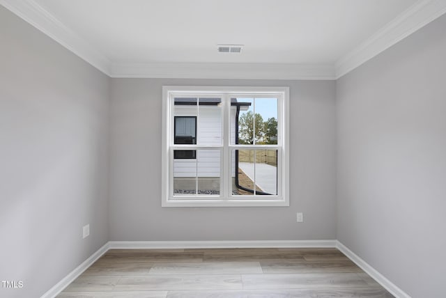 unfurnished room with light hardwood / wood-style floors and crown molding