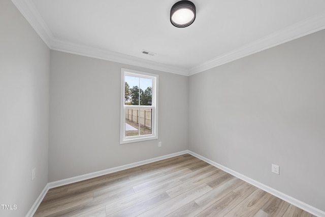 empty room with crown molding and light wood-type flooring