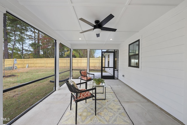 sunroom / solarium with ceiling fan and coffered ceiling