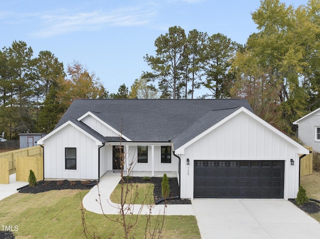 modern farmhouse style home featuring a garage and a front lawn