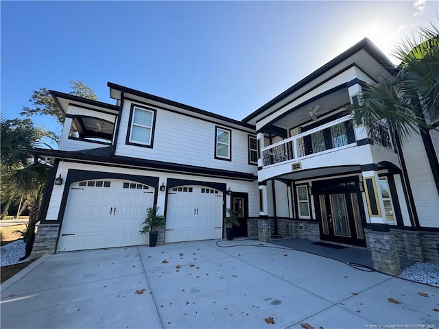 view of front facade with a balcony, a garage, and ceiling fan