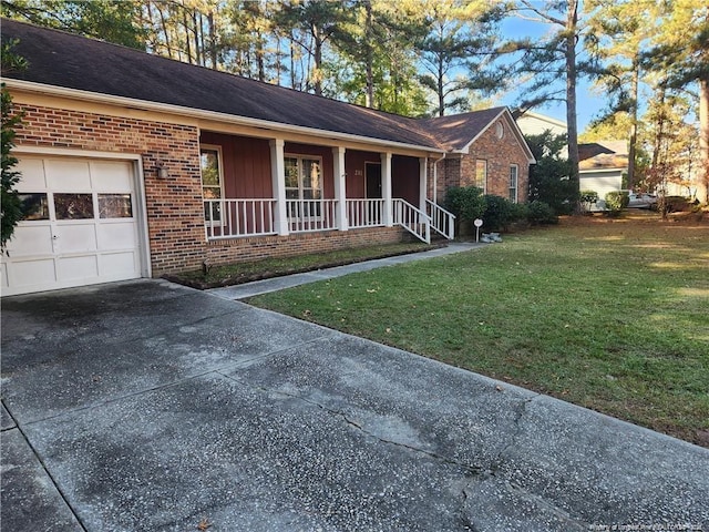 single story home featuring a front yard, a porch, and a garage