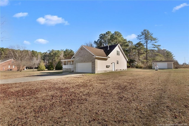 view of home's exterior with a storage unit and a garage