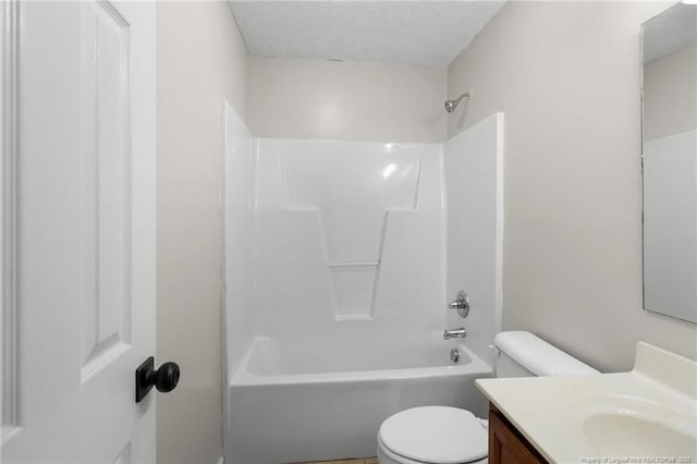 full bathroom featuring vanity, shower / bathing tub combination, a textured ceiling, and toilet