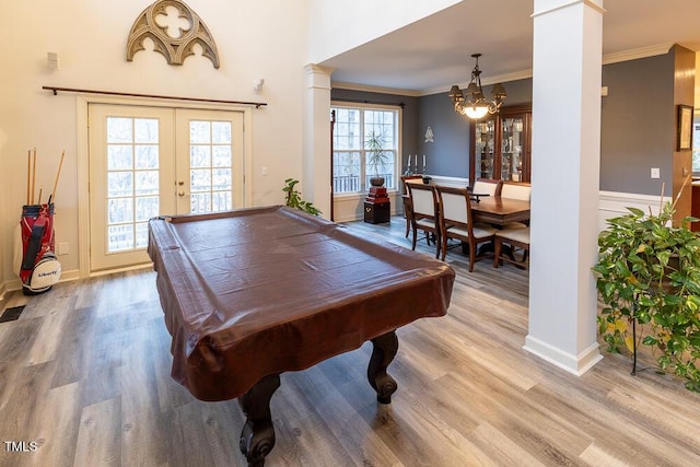 game room featuring french doors, decorative columns, light hardwood / wood-style floors, and pool table