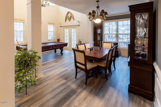 dining room with french doors, dark wood-type flooring, pool table, and an inviting chandelier