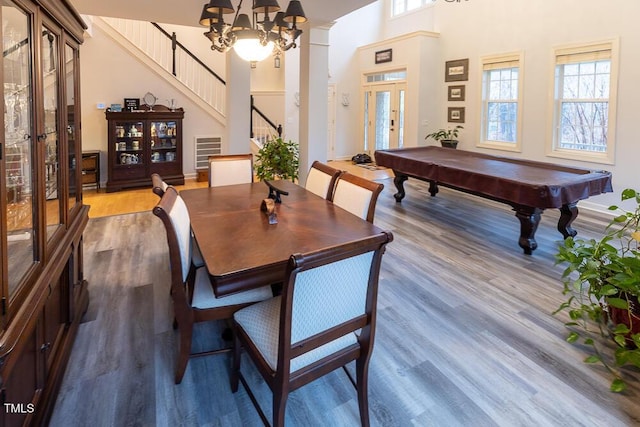 dining room featuring dark hardwood / wood-style floors, an inviting chandelier, plenty of natural light, and french doors