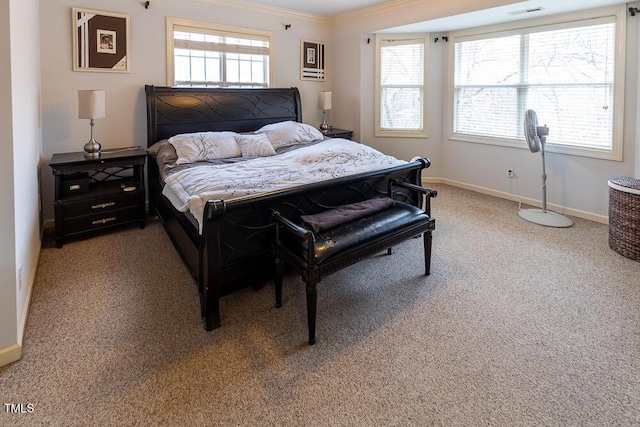 bedroom with ornamental molding, carpet floors, and multiple windows