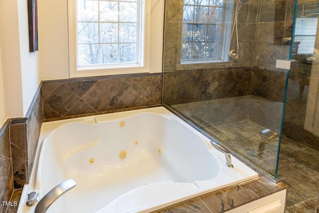 bathroom featuring a relaxing tiled tub