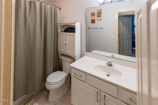 bathroom with tile patterned floors, walk in shower, vanity, and toilet