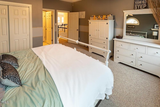 bedroom with light colored carpet and a closet