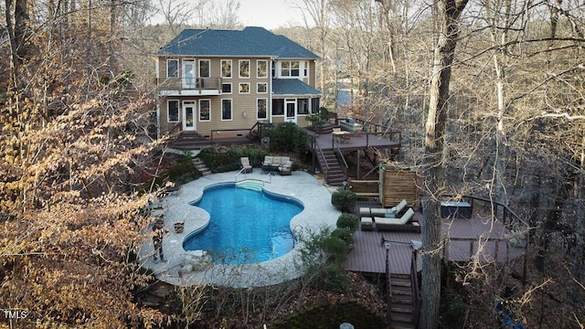 exterior space featuring a swimming pool side deck and a balcony