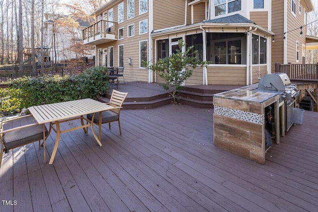 wooden terrace featuring a sunroom