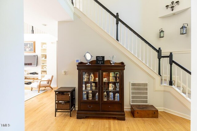 5240 Indigo Moon Way, Raleigh, NC 27613 - stairway with wood finished floors, a towering ceiling, baseboards, and built in features