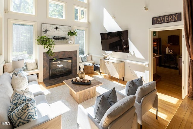 5240 Indigo Moon Way, Raleigh, NC 27613 - living room with plenty of natural light, wood finished floors, a fireplace, and a towering ceiling