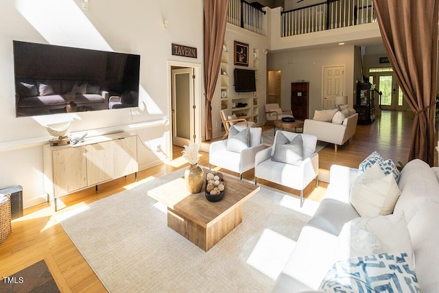 5240 Indigo Moon Way, Raleigh, NC 27613 - living room featuring wood finished floors and a towering ceiling