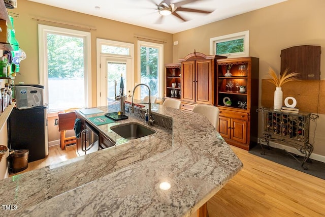 5240 Indigo Moon Way, Raleigh, NC 27613 - kitchen featuring a sink, open shelves, ceiling fan, light wood-style floors, and light stone counters