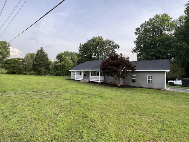 exterior space with covered porch and a front lawn