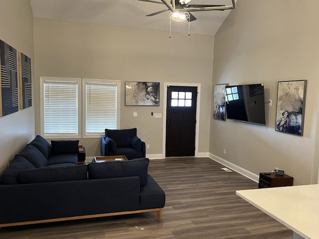 living room featuring ceiling fan, high vaulted ceiling, and dark wood-type flooring