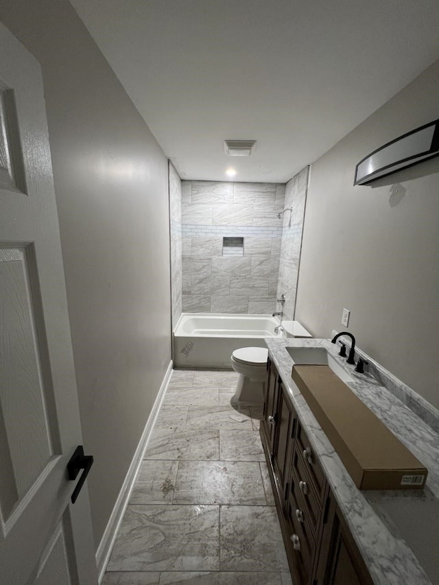 full bathroom featuring vanity, toilet, and tiled shower / bath