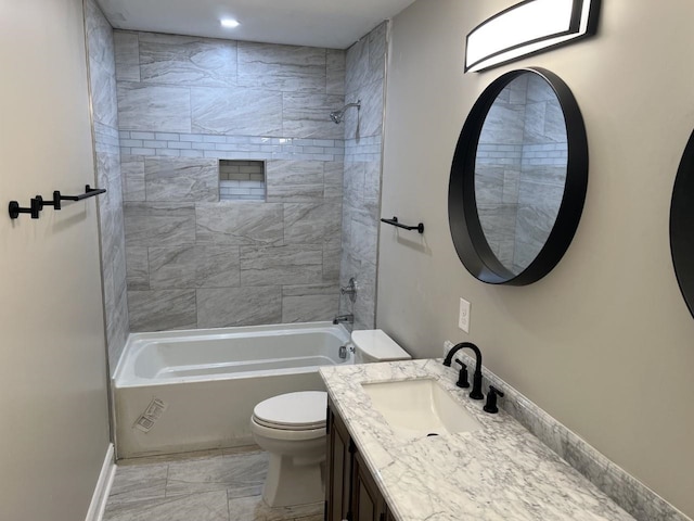 full bathroom featuring vanity, toilet, and tiled shower / bath