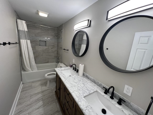 full bathroom featuring vanity, shower / tub combo, and toilet